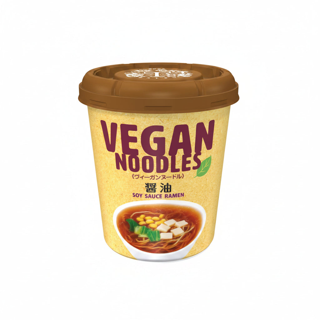 A cup of vegan soy sauce ramen noodles with a brown lid and a beige label featuring the text &