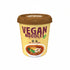 A cup of vegan soy sauce ramen noodles with a brown lid and a beige label featuring the text &